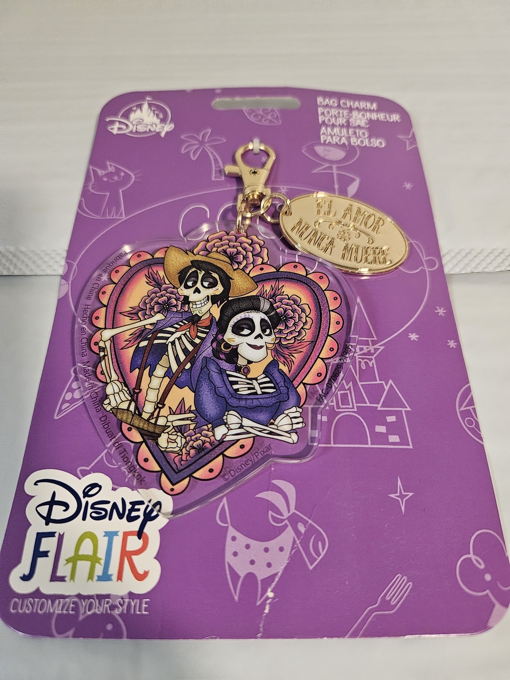 This is a Disney Parks Flair Coco Imelda & Hector Heart Bag Charm Keychain.